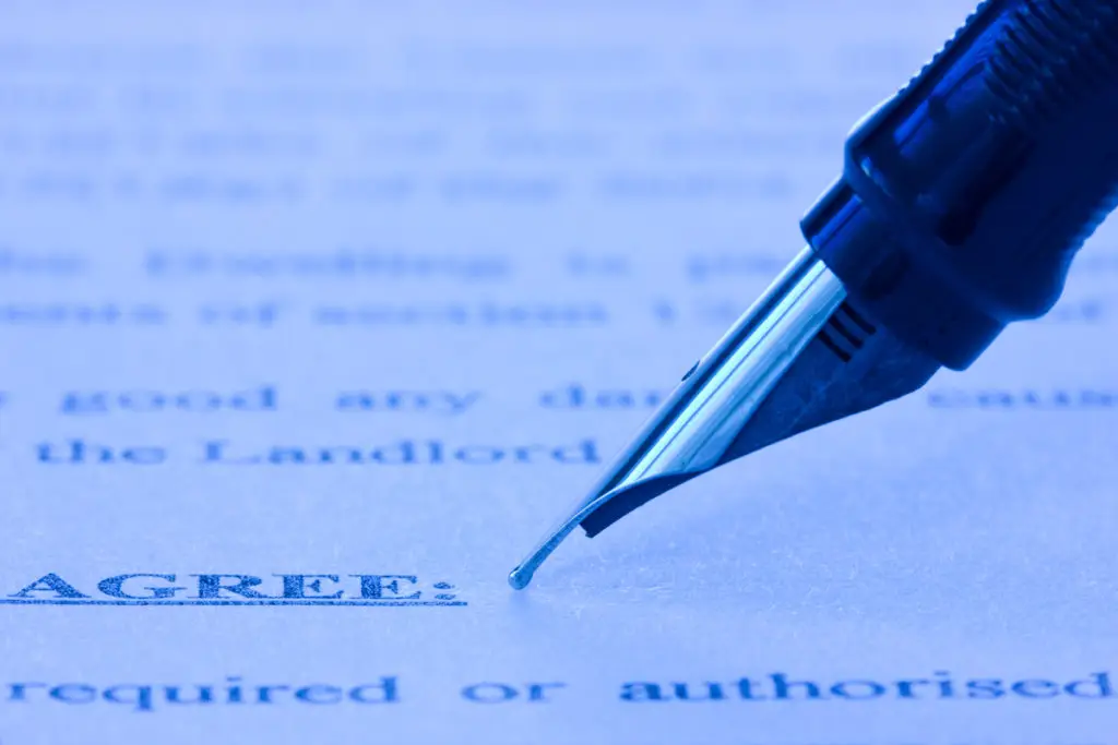 fountain pen and printed agreement