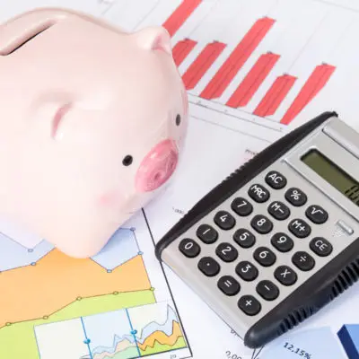 060514 piggy bank and calculator with business charts